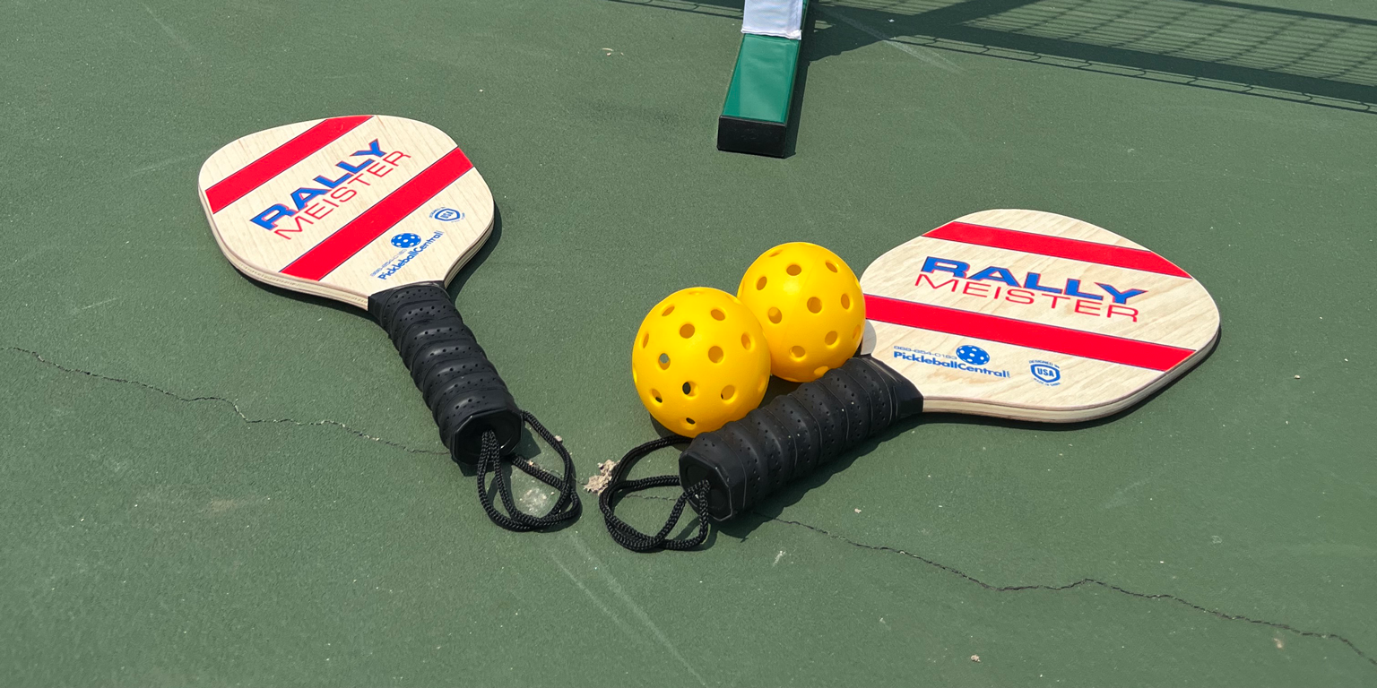 Pickleball equipment next to a net.